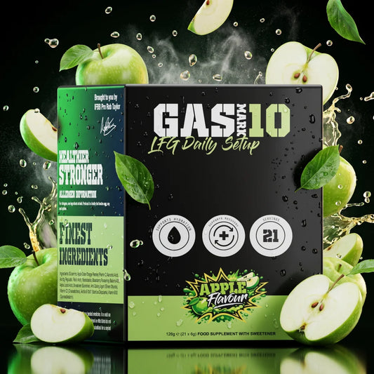 A boxed supplement product labeled 'GAS MARK 10 LFQ Daily Setup' stands against a dark background with green apples, sliced fruit, leaves, and liquid splashes. The box is black with green and white text and icons, and the flavor is marked Apple Flavour.